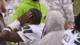 a fox nfl broadcast of a football game with a player touching his head