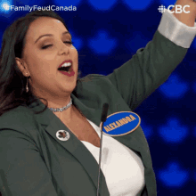 a woman with a name tag that says alexandra stands in front of a microphone