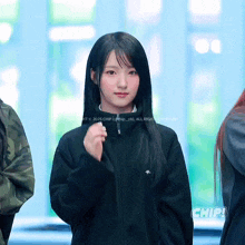 a girl wearing a black jacket with the word chip on the bottom right