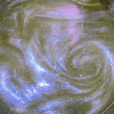 a close up of a purple and green liquid with bubbles