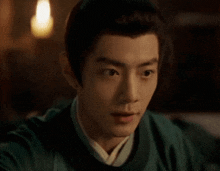 a close up of a man 's face with a surprised look on his face in a dark room .