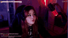 a woman wearing headphones and a microphone is playing a game