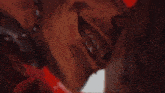 a close up of a person 's face with a red background