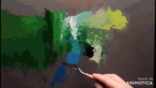 a person is painting with a spoon and the words made in animotica are below them