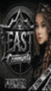 a blurry picture of a woman in front of a sign that says east