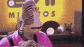 a cartoon character wearing a pink shirt and striped socks is standing in front of a yellow sign .