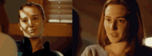 a woman with red hair is smiling and looking at a man