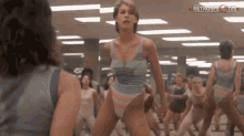 a group of women are doing exercises in front of a mirror with retrospective live written on the bottom right