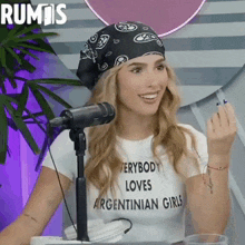 a woman wearing a bandana and a t-shirt that says " everybody loves argentinian girls "