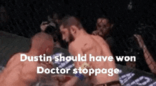 two men are fighting in a boxing ring and the words dustin should have won doctor stoppage are visible .