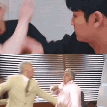 a man in a suit and a woman in a pink shirt are fighting in front of a window .