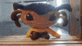 a stuffed animal with a scarf around its neck
