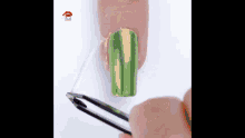 a person is applying green nail polish to another person 's nails .