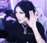 a woman wearing a black shirt with the word sss on the front