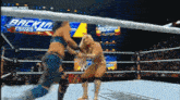 two women are wrestling in a ring with a sign that says backlash