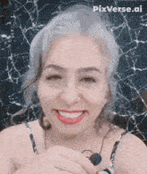 a woman is smiling in front of a cracked screen with pixverse.ai on the bottom