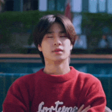 a person wearing a red sweater with the word lonesome on it