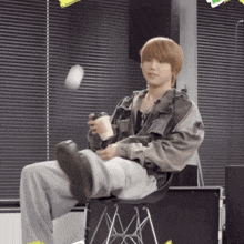 a person sitting on a chair with their feet up holding a cup