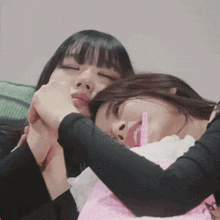 two women are hugging each other with one holding a pink straw