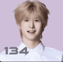 a young man with blonde hair is smiling and wearing a white shirt and tie .