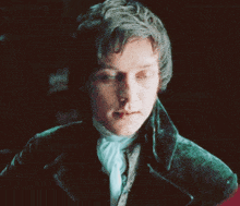 a man in a green jacket and white tie