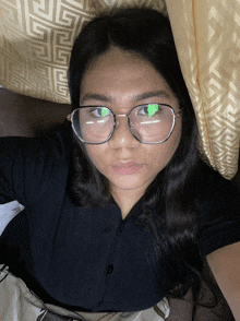a woman wearing glasses and a black shirt