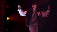 a man in a white shirt is dancing in the dark