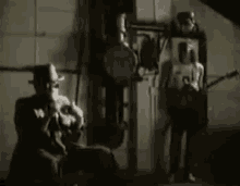 a man in a cowboy hat is playing a banjo