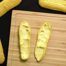 two pieces of bread on a wooden cutting board that says mr. cakes