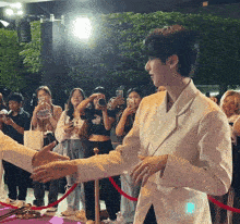 a man in a white jacket shakes hands with a woman