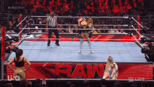 a woman in a wrestling ring with the word raw in the background