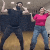 a man and a woman are dancing in a room .