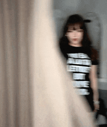 a blurry picture of a woman wearing a t-shirt that says " let 's get naked "