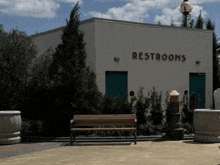 a white building with restrooms written on the side of it
