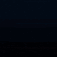 a bunch of candles are lit up in a dark room .