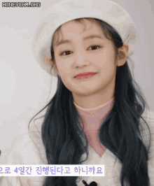 a girl with blue hair wearing a white hat and a pink turtleneck