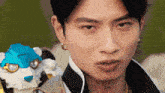 a close up of a man 's face with a robot on his back