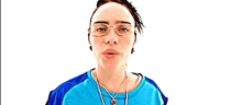 a woman wearing glasses and a blue shirt smiles for the camera