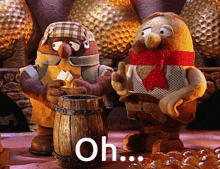 a couple of stuffed animals standing next to a wooden barrel with the word oh on the bottom