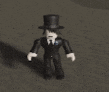 a toy man wearing a top hat and a suit is standing on a gray surface .