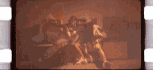 a blurred image of a person sitting on a couch with a light behind them