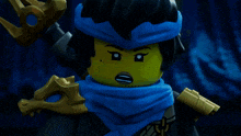 a lego figure with a blue scarf around her head