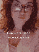 a woman wearing glasses with the words gimme those koala baws