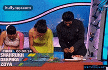 a man and two women are sitting at a table with a plate of food on it .