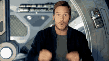 a man with a surprised look on his face is standing in a room