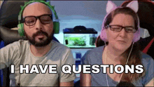 a man and a woman are sitting next to each other and the woman is wearing cat ears and headphones .