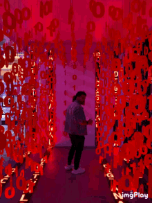 a man is standing in front of a display of red numbers including the number 1
