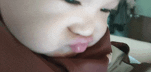 a close up of a person 's face with a slight smirk on it