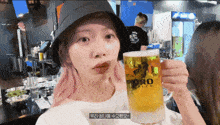a woman with pink hair is holding a glass of beer that says pro on it