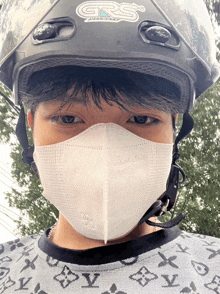 a man wearing a grs helmet and a mask